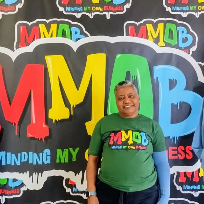 Person walking down a street with graffiti